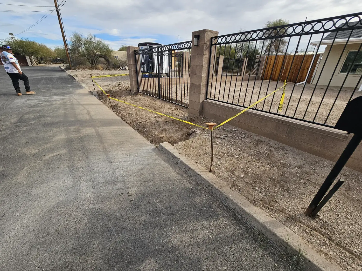 Concrete driveway apron and gate entry