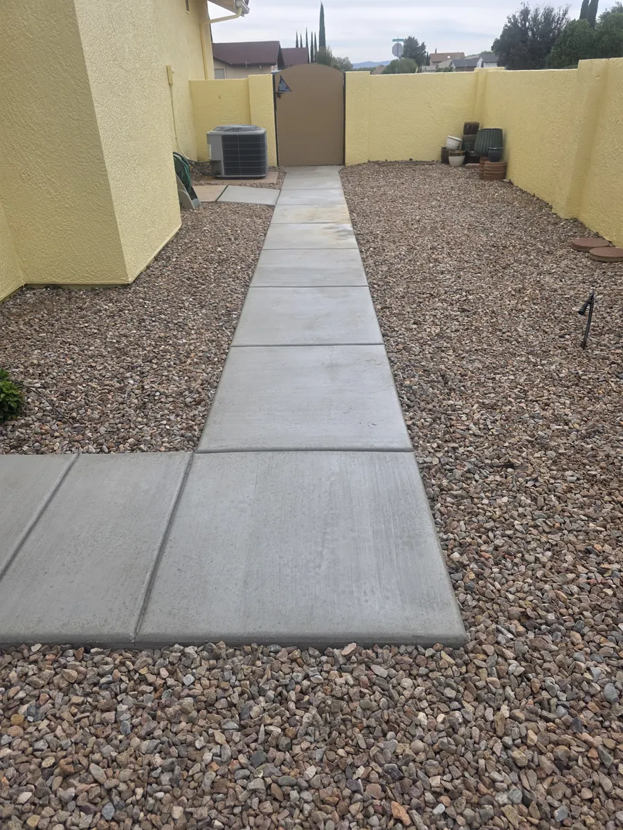 Clean concrete walkway with gravel borders
