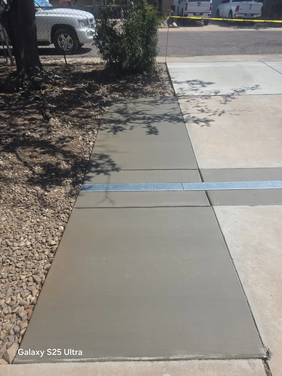 Wide concrete walkway with a channel drain